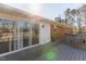 Spacious back deck with sliding glass doors and a connecting walkway, ideal for indoor-outdoor living at 1186 Dick Holeman Rd, Timberlake, NC 27583