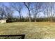 Open backyard view featuring a utility shed set amongst a large grassy area with surrounding trees at 1186 Dick Holeman Rd, Timberlake, NC 27583