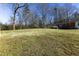 Expansive backyard space showcasing a large grassy area with the house and shed in the background at 1186 Dick Holeman Rd, Timberlake, NC 27583