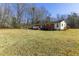 Spacious backyard featuring a long, ranch-style home with a wooden deck and ample yard space at 1186 Dick Holeman Rd, Timberlake, NC 27583