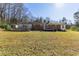 A wide shot of a spacious backyard featuring lush grass and an inviting outdoor space at 1186 Dick Holeman Rd, Timberlake, NC 27583