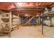 Unfinished basement with exposed ceiling, laundry area, and stairs leading to the upper level at 1186 Dick Holeman Rd, Timberlake, NC 27583