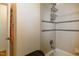 Full bathroom with tiled shower and a convenient wall-mounted storage rack at 1186 Dick Holeman Rd, Timberlake, NC 27583
