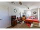 Bright bedroom with a cozy bed, patterned rug, and comfortable armchair at 1186 Dick Holeman Rd, Timberlake, NC 27583