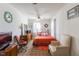 Well-lit bedroom with a cozy bed, patterned rug, and comfortable armchair at 1186 Dick Holeman Rd, Timberlake, NC 27583