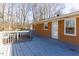 A brick home featuring a spacious outdoor deck and inviting entry door at 1186 Dick Holeman Rd, Timberlake, NC 27583