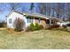 Side view of the home featuring well-kept landscaping and a mix of brick and siding at 1186 Dick Holeman Rd, Timberlake, NC 27583