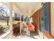 Spacious covered front porch with ample seating, offering a comfortable outdoor living space at 1186 Dick Holeman Rd, Timberlake, NC 27583