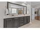 Bathroom features a double vanity with marble countertop and a large framed mirror at 120 Silver Bluff St, Holly Springs, NC 27540
