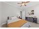 Cozy bedroom features a decorative ceiling fan, a comfortable bed, and a storage unit at 120 Silver Bluff St, Holly Springs, NC 27540