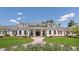 Elegant clubhouse with symmetrical design, manicured lawns, and inviting walkway, perfect for community gatherings and events at 120 Silver Bluff St, Holly Springs, NC 27540