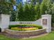 Well-maintained community entrance with stone accents, lush landscaping, and an elegant neighborhood sign at 120 Silver Bluff St, Holly Springs, NC 27540