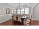 Elegant dining room featuring a chandelier, large windows, and ample seating at 120 Silver Bluff St, Holly Springs, NC 27540