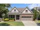 Charming brick home with attached two car garage and manicured front lawn landscaping at 120 Silver Bluff St, Holly Springs, NC 27540
