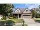 Charming home with a well-maintained front yard, brick facade, and two-car garage at 120 Silver Bluff St, Holly Springs, NC 27540