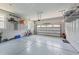 Spacious two-car garage with epoxy flooring and storage shelving, providing ample space for vehicles and organization at 120 Silver Bluff St, Holly Springs, NC 27540