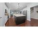 Open concept kitchen with hardwood floors, large island, and stainless steel appliances at 120 Silver Bluff St, Holly Springs, NC 27540