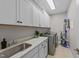 Well-organized laundry room with modern appliances, ample cabinet space, and a practical sink at 120 Silver Bluff St, Holly Springs, NC 27540
