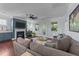 Inviting living room featuring a fireplace, comfortable seating, hardwood floors, and a ceiling fan at 120 Silver Bluff St, Holly Springs, NC 27540