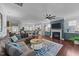 Open concept living space with kitchen, fireplace, ceiling fan, hardwood floors, and comfortable seating at 120 Silver Bluff St, Holly Springs, NC 27540