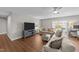 Spacious living room features hardwood floors, a ceiling fan, and ample seating at 120 Silver Bluff St, Holly Springs, NC 27540