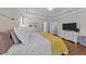 Cozy bedroom with hardwood floors, a TV, and a chest of drawers at 120 Silver Bluff St, Holly Springs, NC 27540
