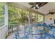Relaxing screened-in patio area with comfortable seating and views of the lush backyard at 120 Silver Bluff St, Holly Springs, NC 27540