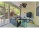 Inviting screened-in patio area with cozy furniture and a mounted television at 120 Silver Bluff St, Holly Springs, NC 27540