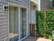 Cozy back porch featuring a wooden privacy screen and sliding glass door to the interior at 121 Brentfield Loop, Morrisville, NC 27560