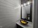 A bathroom with a striking gold vessel sink, white shiplap walls, and decorative mirror at 121 Brentfield Loop, Morrisville, NC 27560