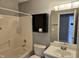 This bathroom features a tub-shower, vanity, mirror, and cabinet at 121 Brentfield Loop, Morrisville, NC 27560