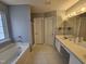 Bathroom with bathtub, tiled floors, and double vanity at 121 Brentfield Loop, Morrisville, NC 27560