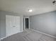 This bedroom offers neutral walls, plush carpeting, and an ample closet at 121 Brentfield Loop, Morrisville, NC 27560