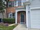 Charming front entrance with a brick facade and a well-manicured yard at 121 Brentfield Loop, Morrisville, NC 27560