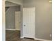 Image captures the hallway with doors and neutral paint, highlighting the floor at 121 Brentfield Loop, Morrisville, NC 27560