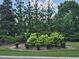 Community landscaping featuring trimmed bushes, flowers, and verdant trees at 121 Brentfield Loop, Morrisville, NC 27560