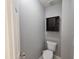 Powder room featuring a standard toilet with a dark brown storage cabinet at 121 Brentfield Loop, Morrisville, NC 27560