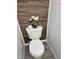 A well-kept toilet with a wooden-look accent wall and a decorative vase of flowers at 121 Brentfield Loop, Morrisville, NC 27560