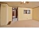 Spacious bedroom with neutral carpeting, ceiling fan, and view into another room at 124 Jack Bennett Rd, Chapel Hill, NC 27517