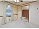 Bedroom with plush carpeting, window with curtains, and view of kitchen through swinging door at 124 Jack Bennett Rd, Chapel Hill, NC 27517