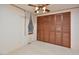 Bedroom featuring plush carpeting, large window with curtains, and a spacious closet at 124 Jack Bennett Rd, Chapel Hill, NC 27517