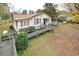 Exterior view of home featuring a ramp, small porch, and side yard at 124 Jack Bennett Rd, Chapel Hill, NC 27517