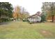 Home featuring a well-kept lawn, mature trees, and inviting front porch at 124 Jack Bennett Rd, Chapel Hill, NC 27517