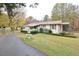 Charming home with manicured landscaping, covered porch, fountain, and a long driveway at 124 Jack Bennett Rd, Chapel Hill, NC 27517