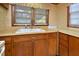 Kitchen close up featuring wood cabinets, laminate countertops, and stainless steel sink at 124 Jack Bennett Rd, Chapel Hill, NC 27517