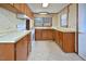 Modest kitchen with laminate countertops, wood cabinets, and white appliances at 124 Jack Bennett Rd, Chapel Hill, NC 27517