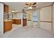 Carpeted living room featuring a ceiling fan and an open view to the kitchen at 124 Jack Bennett Rd, Chapel Hill, NC 27517