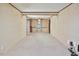 Bright living room with neutral carpeting and view into the entryway at 124 Jack Bennett Rd, Chapel Hill, NC 27517