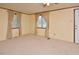 Large living room with carpet, ceiling fan and tan walls with white trim at 124 Jack Bennett Rd, Chapel Hill, NC 27517