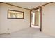 Living room featuring neutral carpet and walls, connecting to another room through an open doorway at 124 Jack Bennett Rd, Chapel Hill, NC 27517